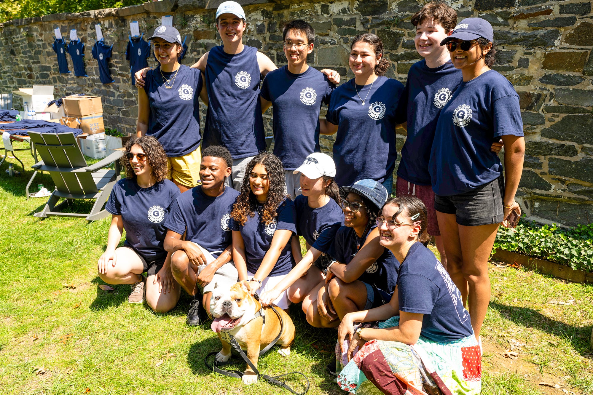 A group of 12 students stands with Jack the Bulldog.