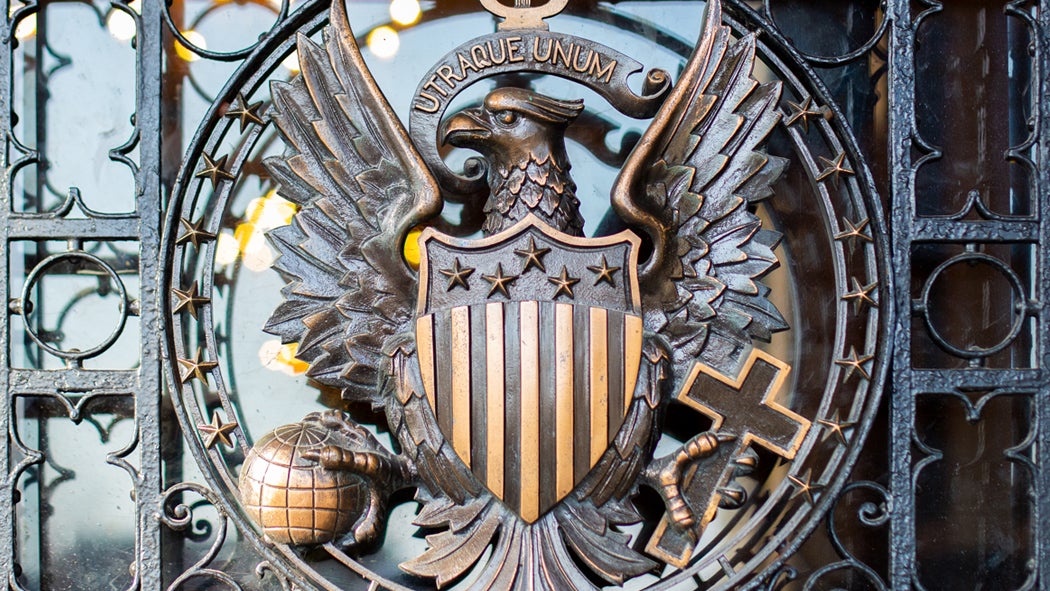 An iron Georgetown seal is displayed on the front doors of Healy Hall.