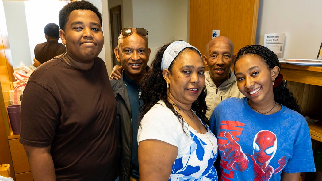A family of five pose for the camera during new student move-in.